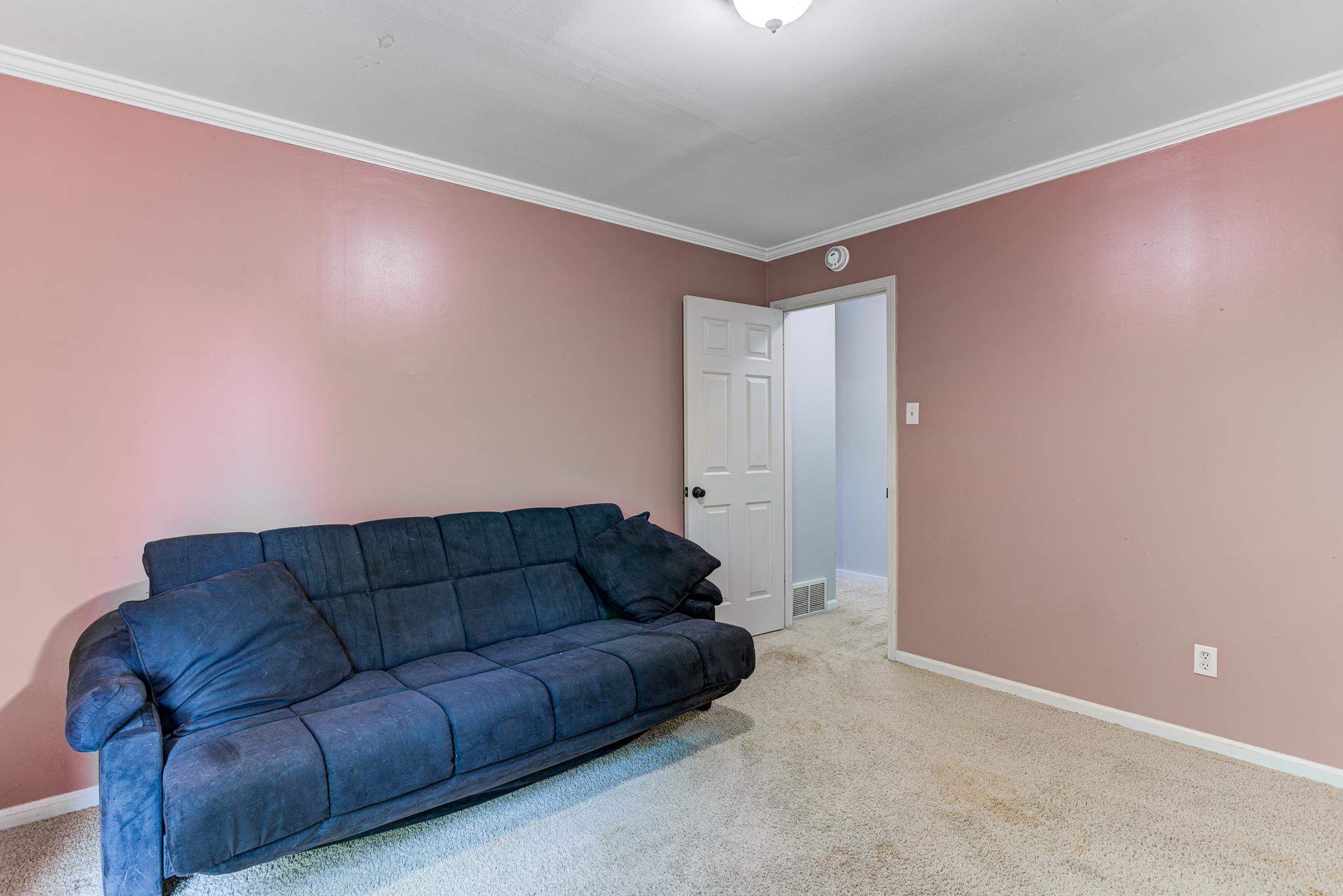 218 South Walnut Bend Road Memphis, TN 38018 - Photo 18 of 25 Carpeted living room with crown molding and baseboards