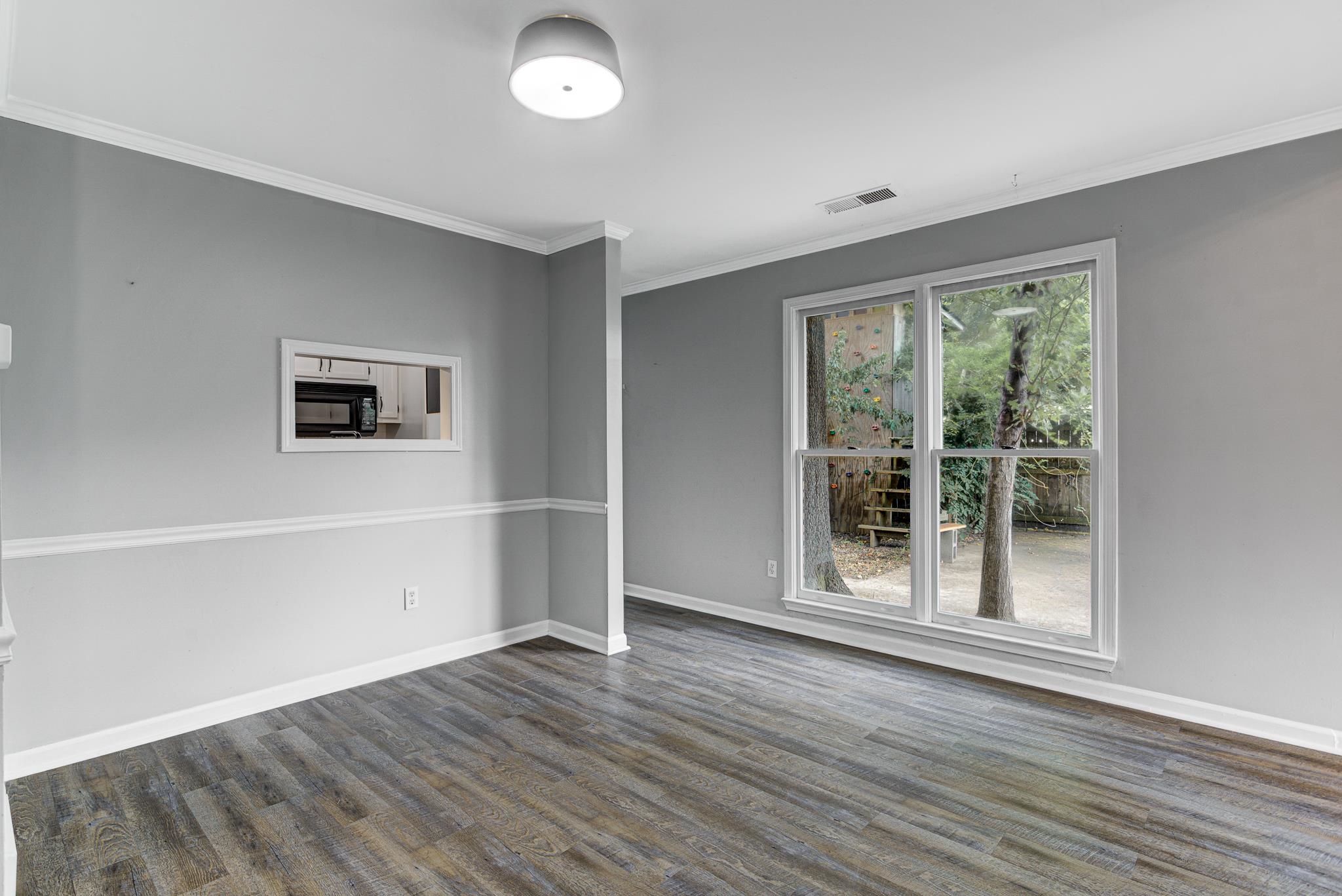 218 South Walnut Bend Road Memphis, TN 38018 - Photo 20 of 25 Empty room with ornamental molding and dark wood-type flooring