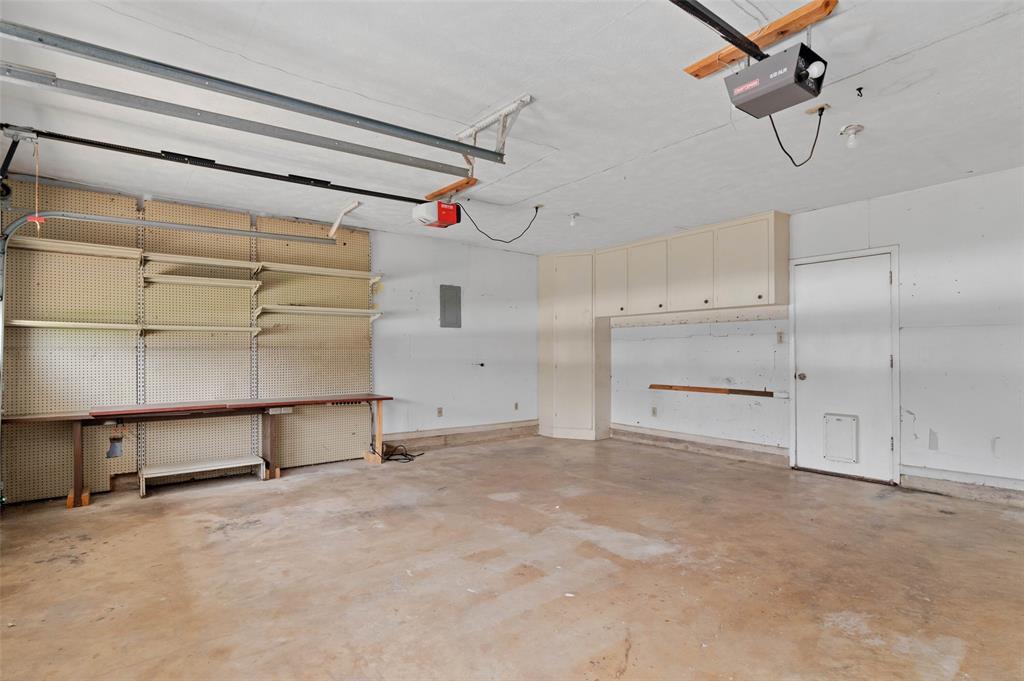 301 East 6th Street Krum, TX 76249 - Photo 24 of 29 Spacious garage with built in shelving and cabinetry.