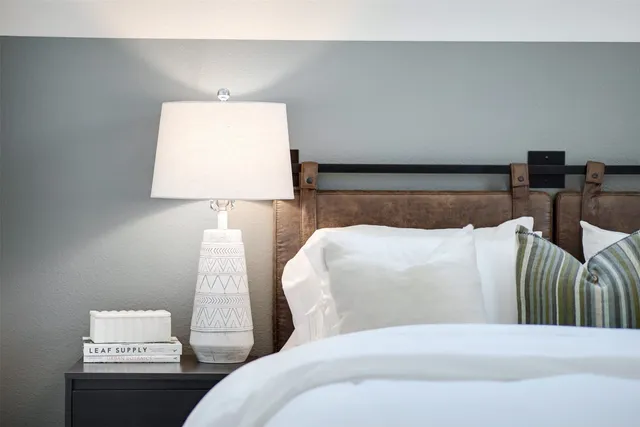 a bed sitting in a bedroom and lamp