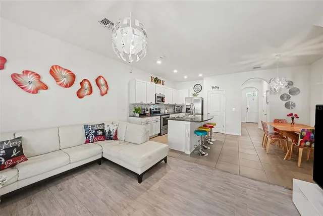a living room with furniture and kitchen view