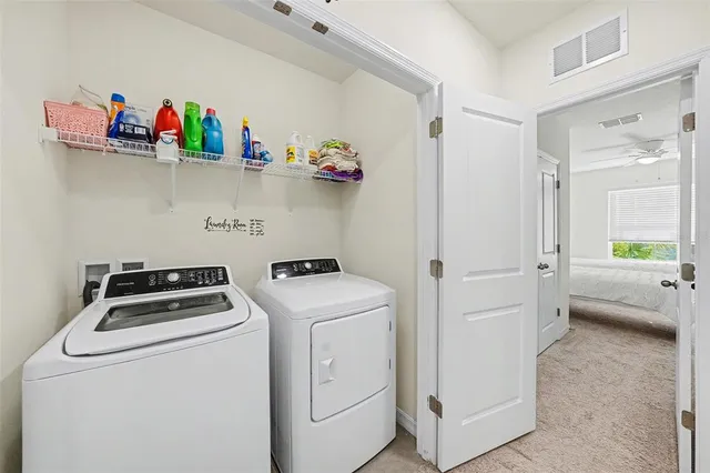 a view of storage and utility room with washer and dryer