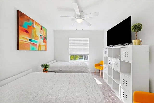 a bedroom with furniture and a flat screen tv