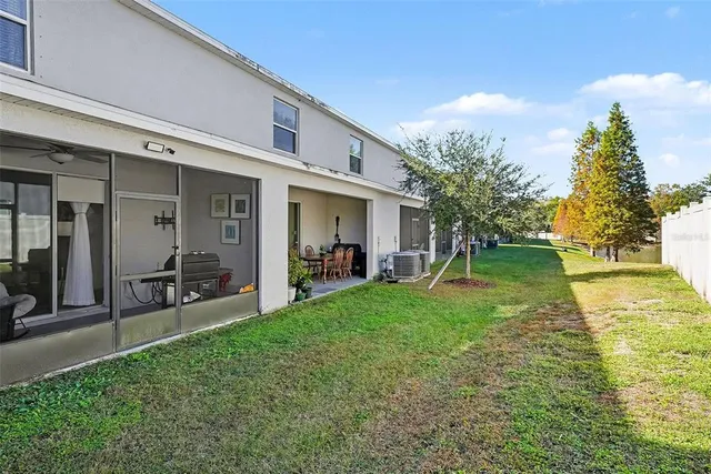 a view of a house with backyard porch and sitting area