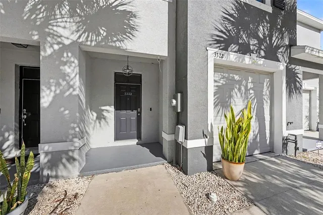a view of a hallway with wooden floor and a potted plant