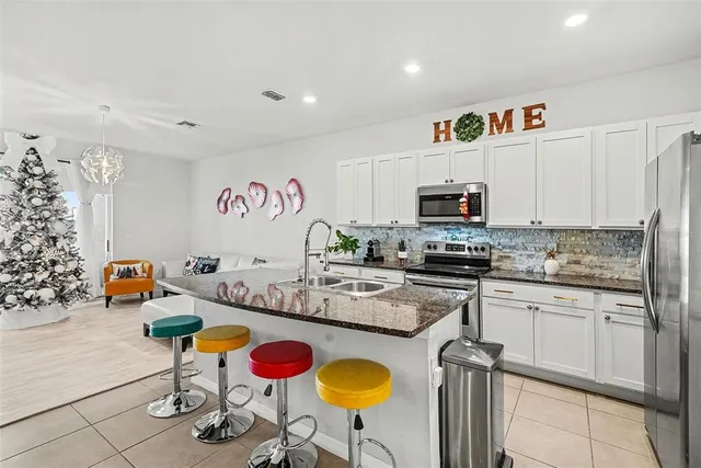 a kitchen with stainless steel appliances granite countertop a sink and cabinets
