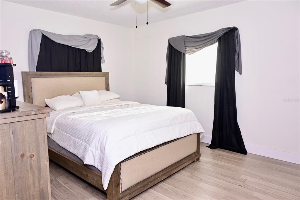 306 Fern Road Winter Haven, FL 33880 - Photo 11 of 20 a bedroom with a bed and a mirror