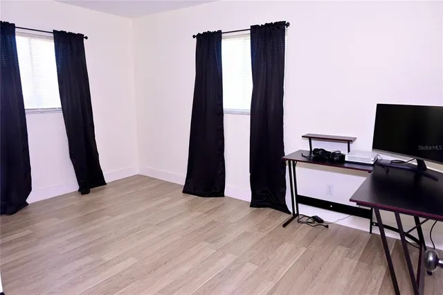 a view of workspace with hardwood floor