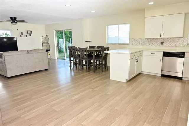 a view of a kitchen with furniture and wooden floor