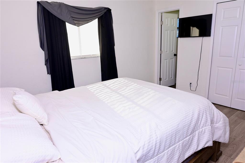 306 Fern Road Winter Haven, FL 33880 - Photo 9 of 20 a bedroom with a bed and a mirror