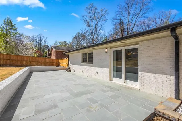 a swimming pool with an outdoor space and seating area