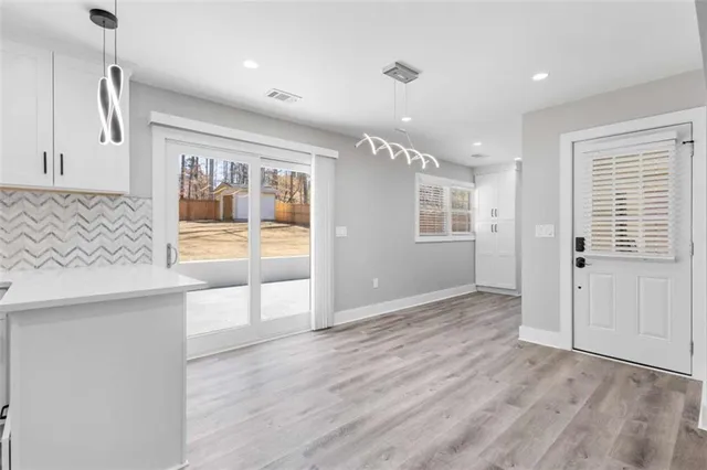 a kitchen with kitchen island a counter top space a sink stainless steel appliances and cabinets