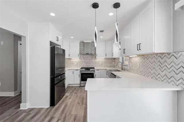 a kitchen with granite countertop white cabinets and white appliances