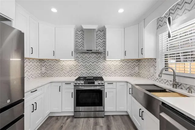 a kitchen with a sink stove and cabinets