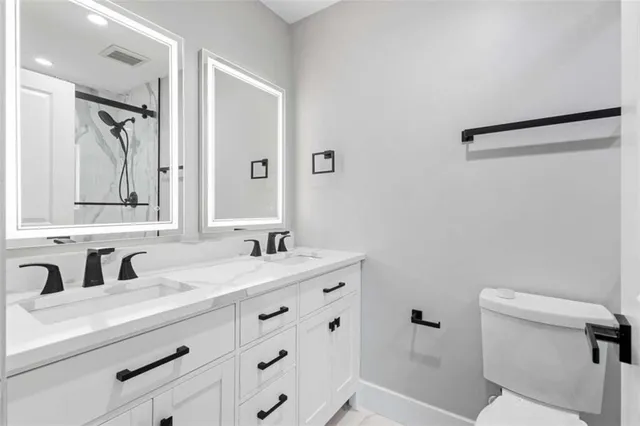 a view of a storage & utility room with two washing machine