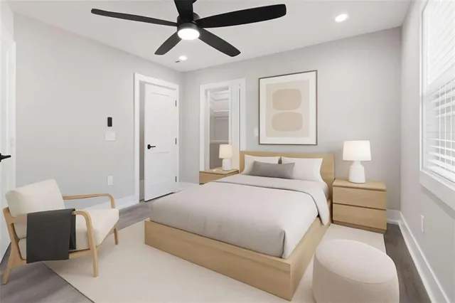 a spacious bedroom with a bed and a chandelier