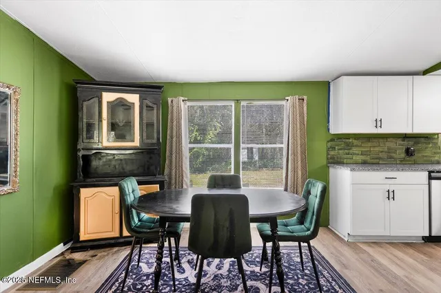a view of a dining room with furniture window and outside view