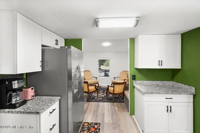 a kitchen with stainless steel appliances granite countertop a refrigerator and a stove