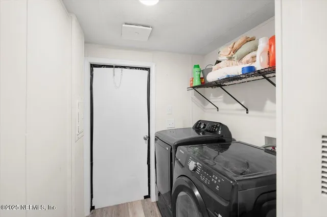 a view of storage and utility room with washer and dryer