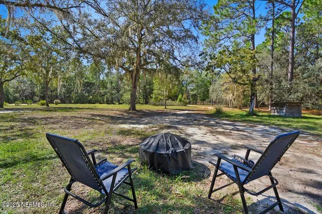 a view of a backyard with table and chairs and couches