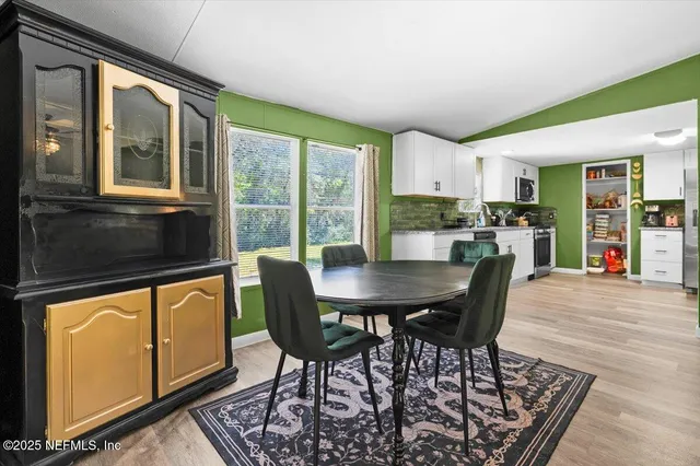 a view of a dining room with furniture window and outside view