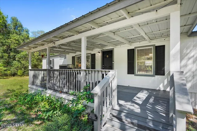 a view of a house with wooden fence