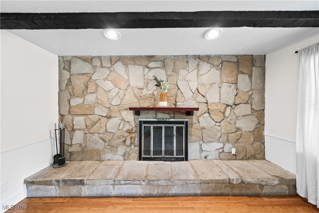 3111 Blake Road Ashtabula, OH 44004 - Photo 10 of 39 Room details with hardwood / wood-style flooring and a stone fireplace