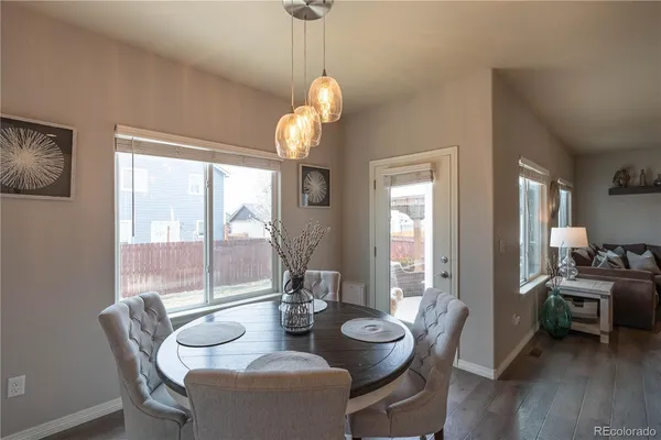 a view of a dining room with furniture wooden floor and a chandelier