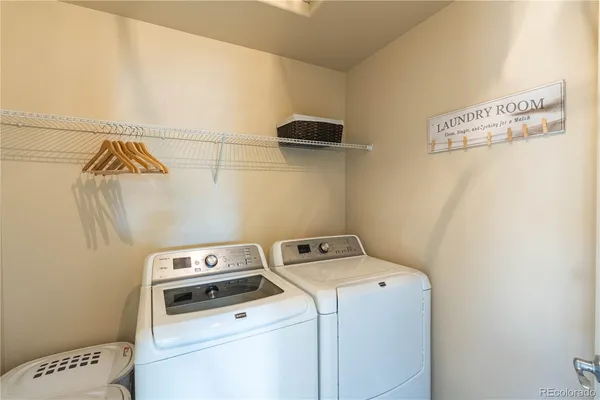 a view of storage and utility room with washer and dryer