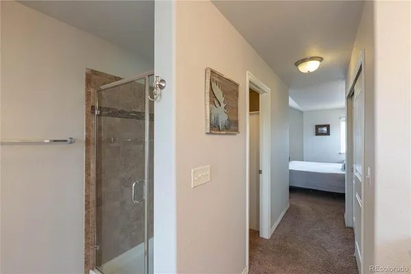 a view of a bathroom with a glass door shower