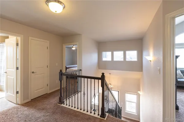 a view of a hallway to a livingroom with furniture