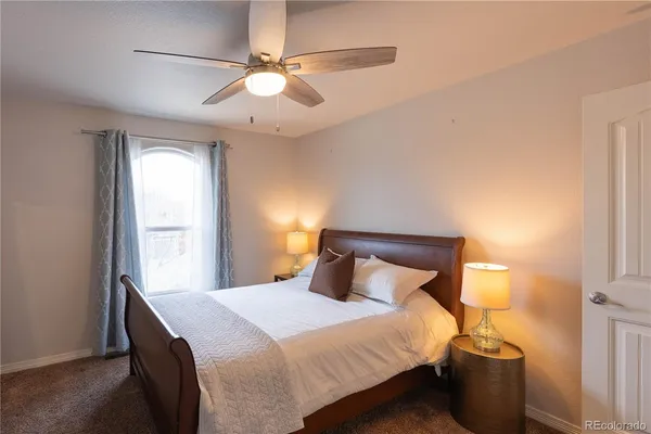 a bedroom with a bed and a chandelier