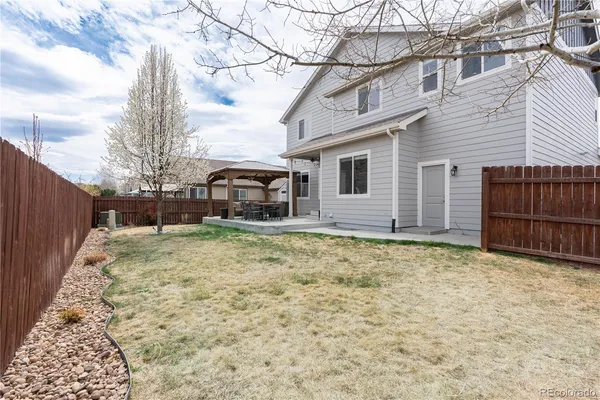 a view of a patio with table and chairs
