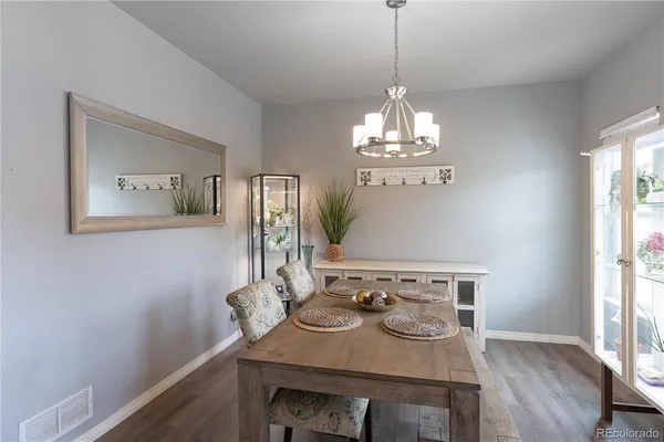 a view of a dining room with furniture and wooden floor