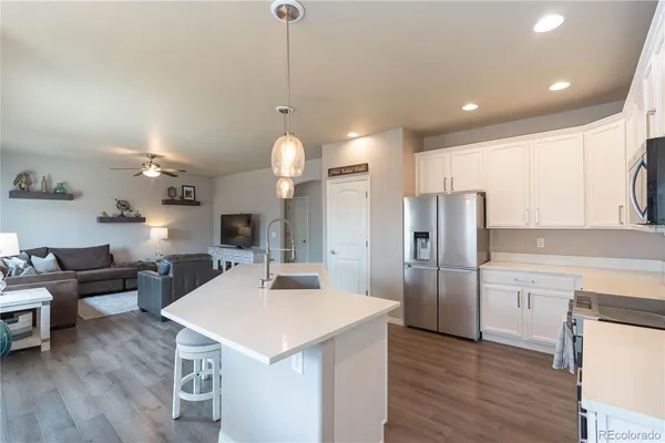 a kitchen with refrigerator cabinets and wooden floor
