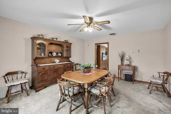 a kitchen with stainless steel appliances granite countertop a refrigerator a sink dishwasher a stove with wooden cabinets and floor