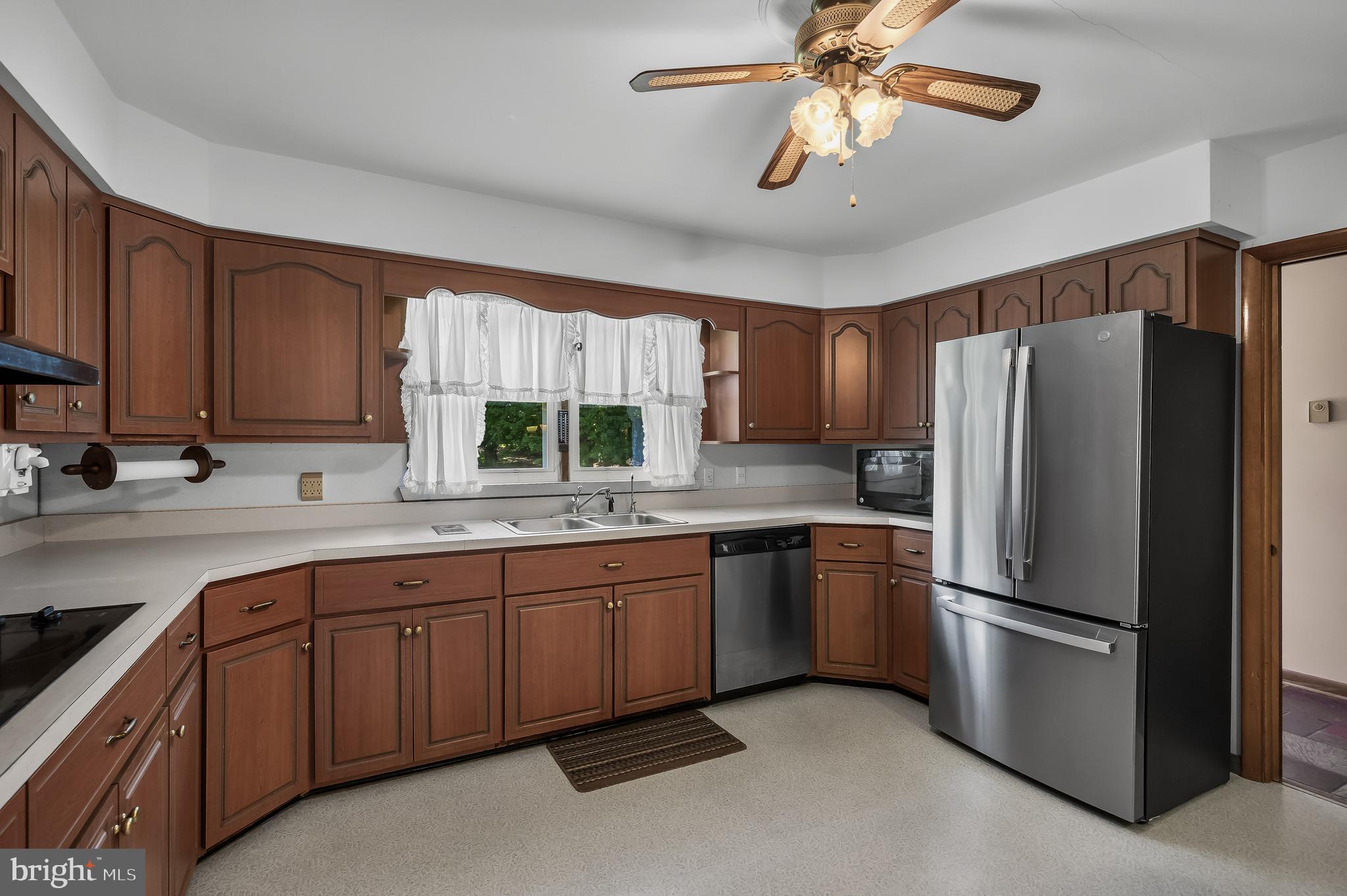 44 Supawna Road Pennsville, NJ 08070 - Photo 14 of 56 a kitchen with stainless steel appliances granite countertop a refrigerator a sink dishwasher a stove and white countertops with wooden floor