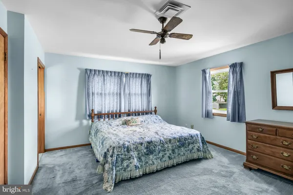 a bed sitting in a room next to a window