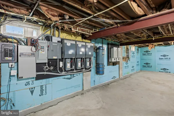 a kitchen with white cabinets and a window