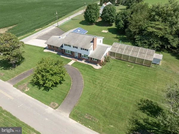 an aerial view of a house with a yard
