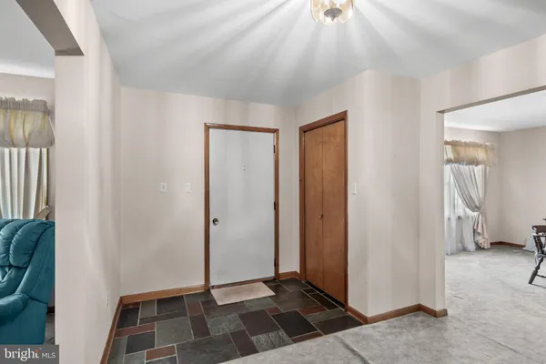 a view of entryway with wooden floor and stairs