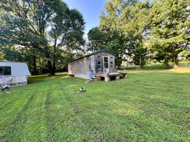 a view of a house with a backyard