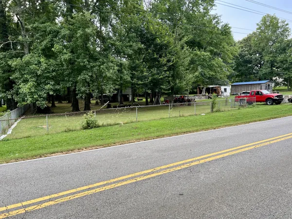 an aerial view of a residential houses with yard