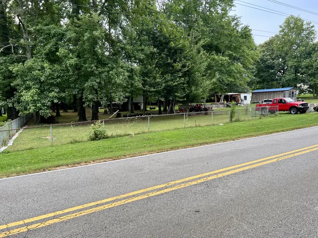 an aerial view of a residential houses with yard