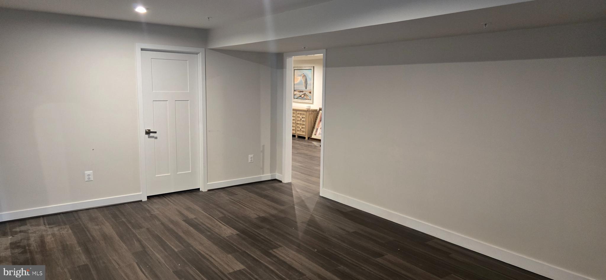 6005 Calla Place Frederick, MD 21703 - Photo 15 of 30 a view of an empty room with wooden floor and a window