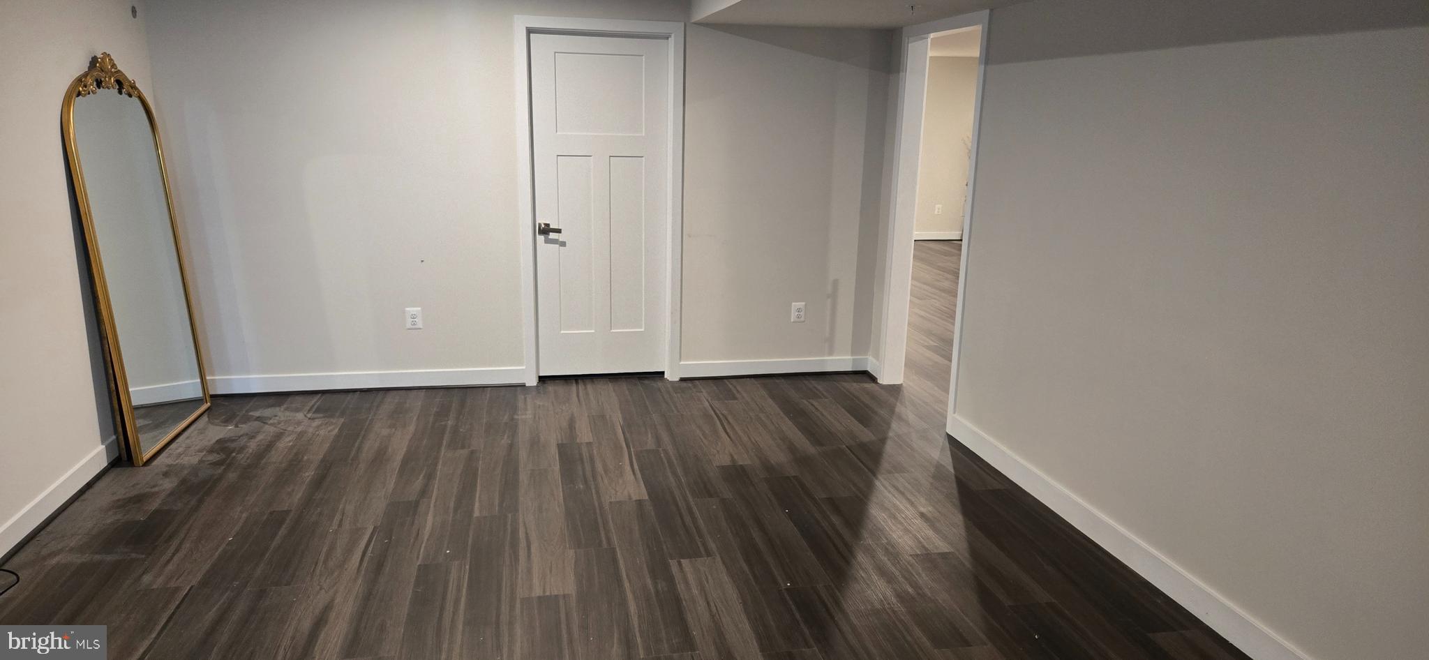6005 Calla Place Frederick, MD 21703 - Photo 16 of 30 a view of a room with wooden floor and white doors