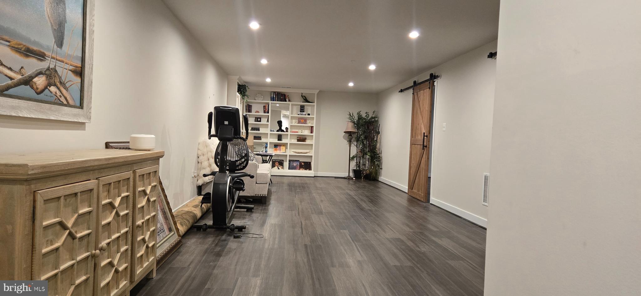 6005 Calla Place Frederick, MD 21703 - Photo 19 of 30 a view of empty room with wooden floor