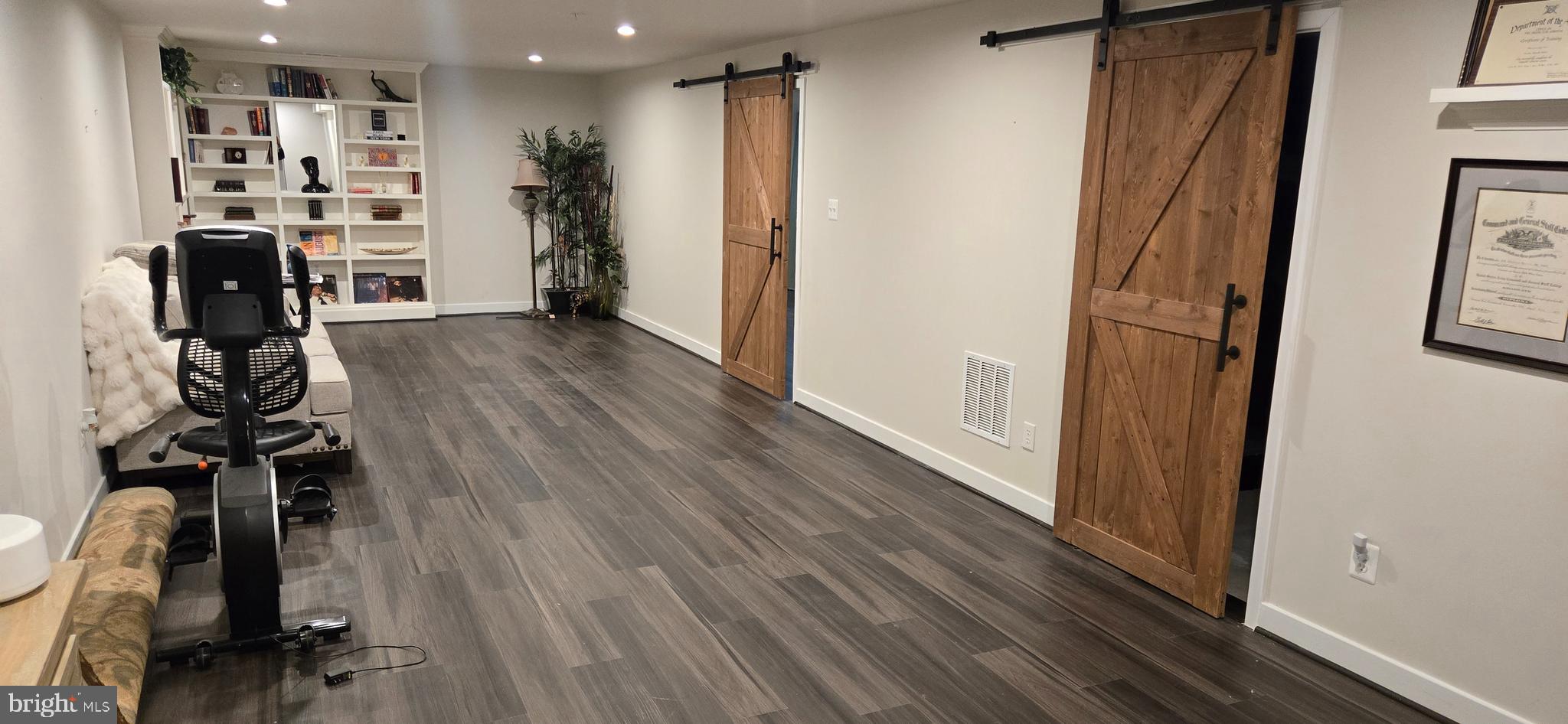 6005 Calla Place Frederick, MD 21703 - Photo 22 of 30 a view of a hallway with wooden floor and closet