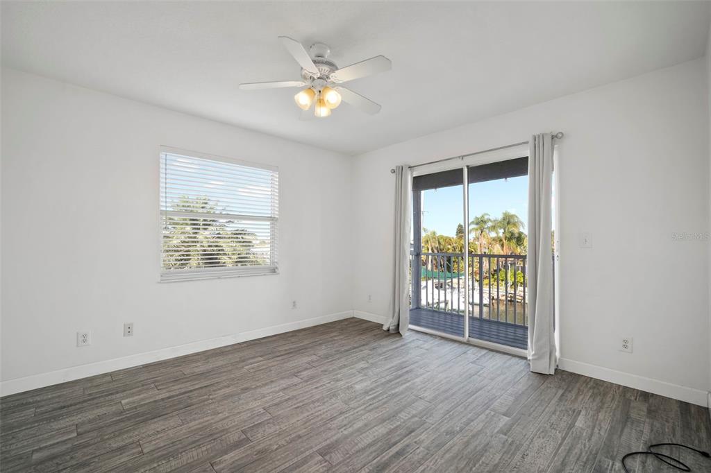 1013 Apollo Beach Boulevard, Unit 203 Apollo Beach, FL 33572 - Photo 22 of 26 an empty room with wooden floor and windows