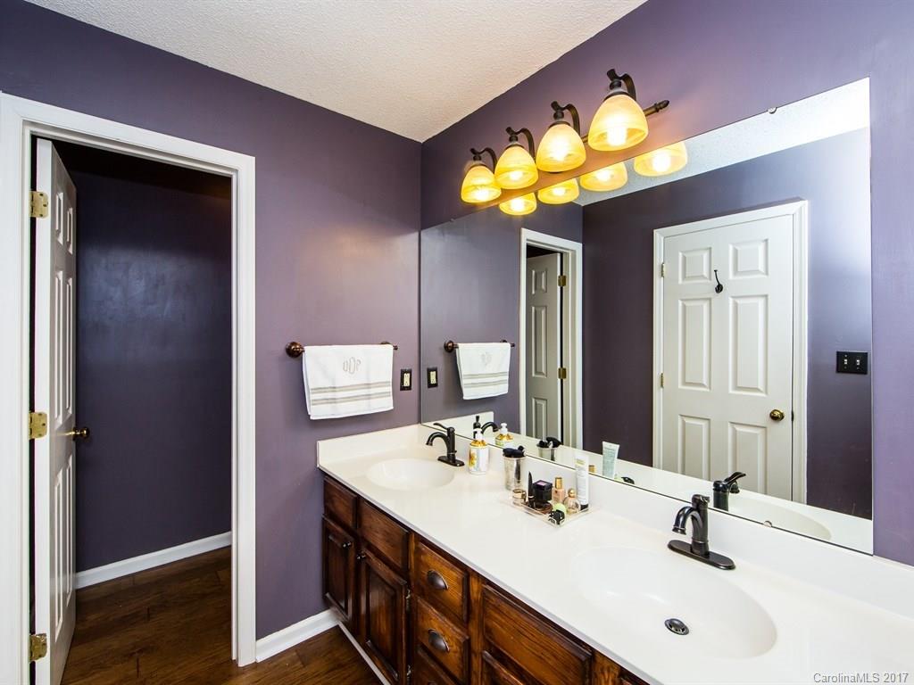 5003 Sharon Road, Unit B Charlotte, NC 28210 - Photo 11 of 20 a bathroom with a sink and a mirror